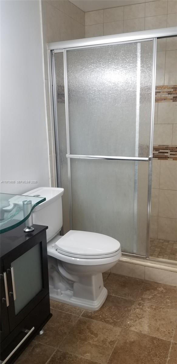 8250 Southwest 149th Court, Unit 8210 Miami, FL 33193 - Photo 21 of 23 a white toilet sitting next to a bathroom sink