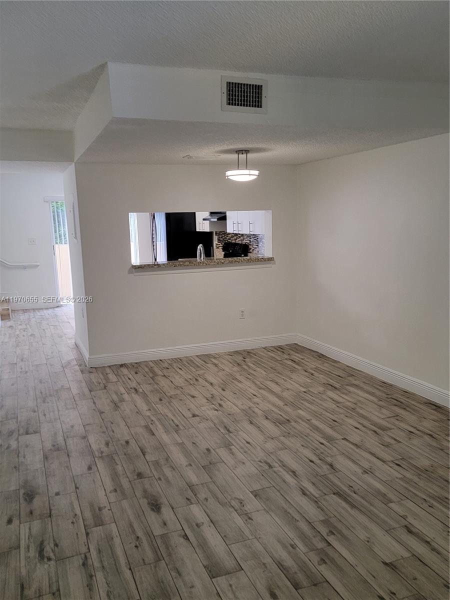 8250 Southwest 149th Court, Unit 8210 Miami, FL 33193 - Photo 7 of 23 a view of empty room with wooden floor