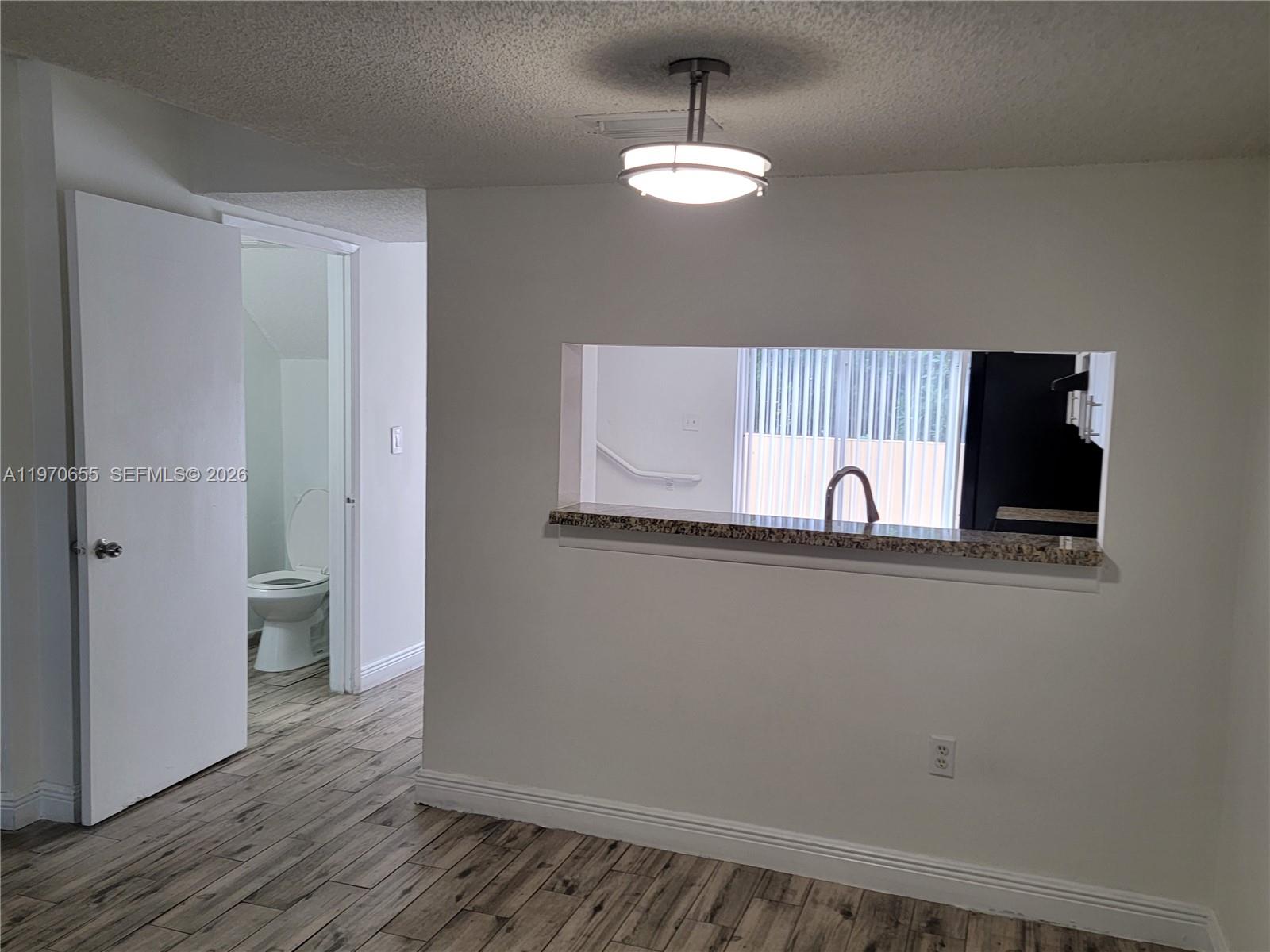8250 Southwest 149th Court, Unit 8210 Miami, FL 33193 - Photo 9 of 23 a view of a livingroom with wooden floor