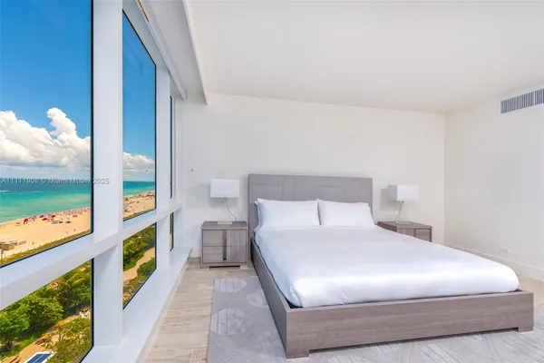 a bedroom with a bed and a painting on the wall