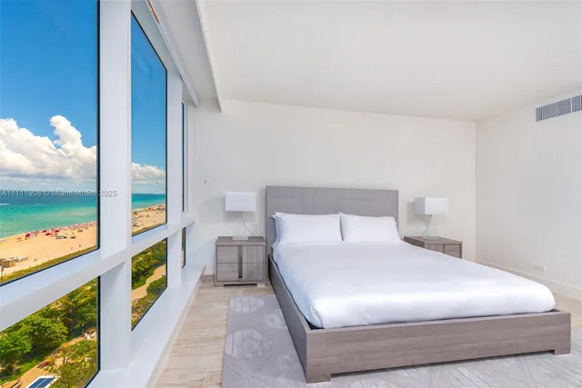 a bedroom with a bed and a painting on the wall