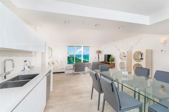 a dining room with furniture and a large window