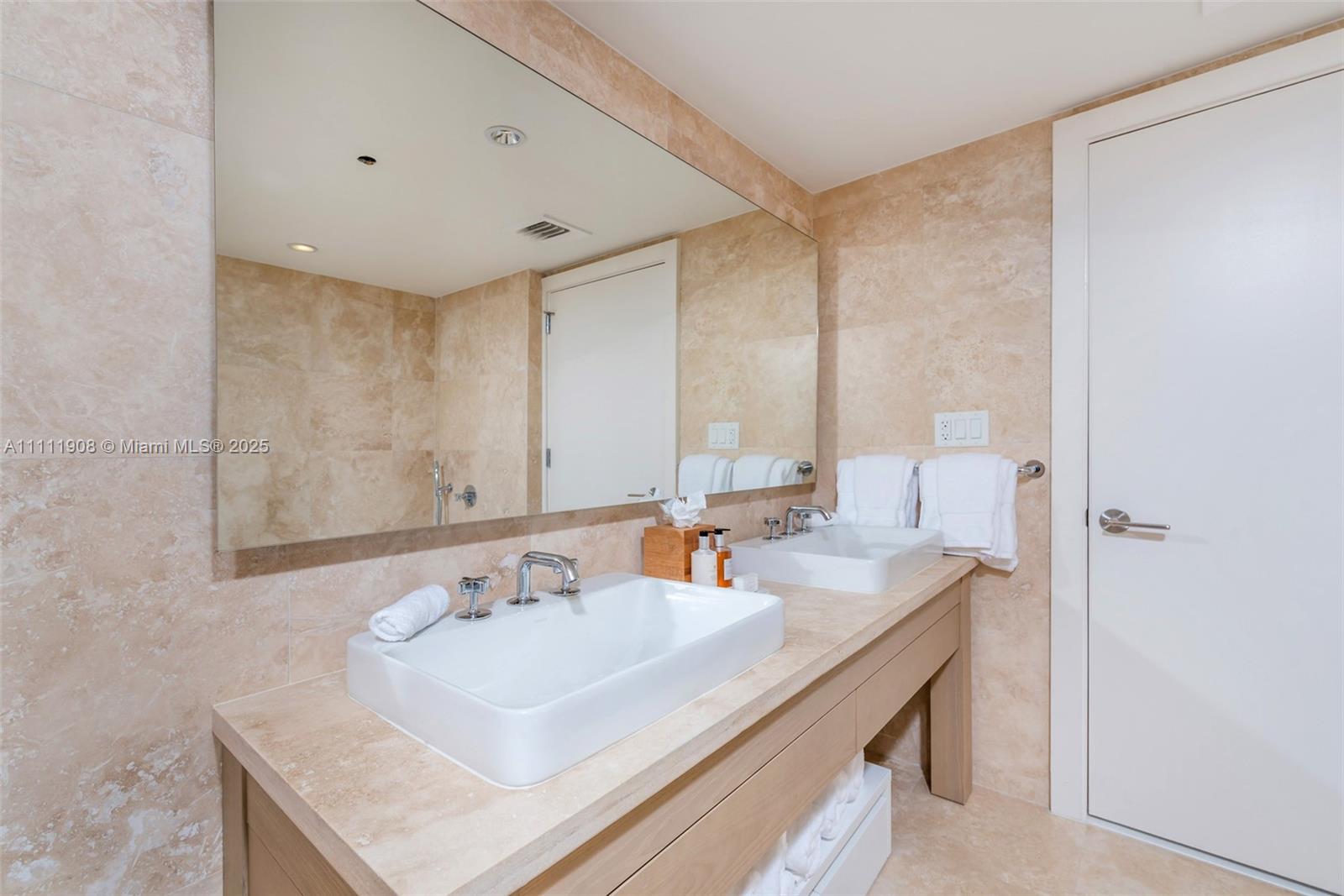 102 24th Street, Unit 1019 Miami Beach, FL 33139 - Photo 22 of 27 a bathroom with a sink and a mirror
