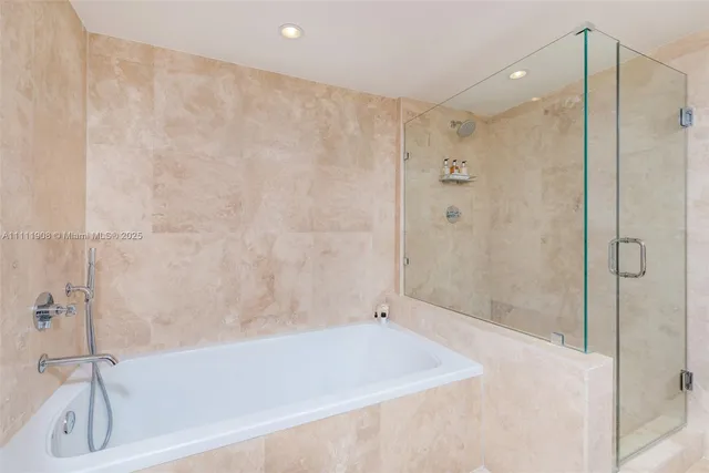 a bathroom with a shower and a tub
