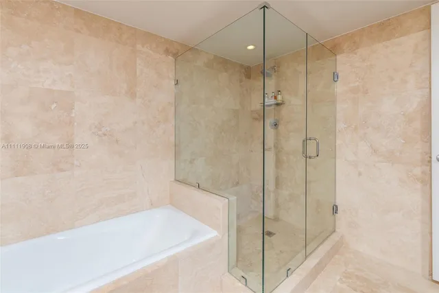 a bathroom with a shower and a bath tub