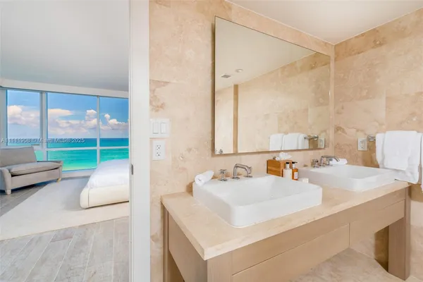 a bathroom with a sink double vanity and a tub