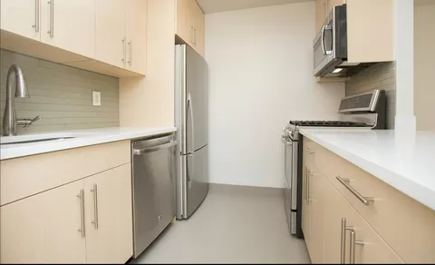 a utility room with cabinets washer and dryer