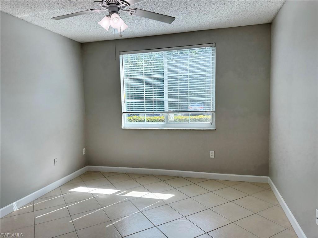 1200 Reserve Way, Unit 103 Naples, FL 34105 - Photo 15 of 26 a view of an empty room with a window