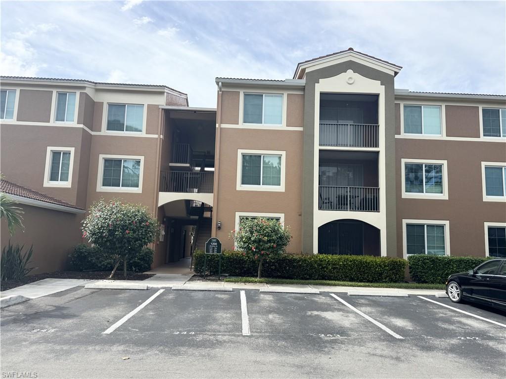 1200 Reserve Way, Unit 103 Naples, FL 34105 - Photo 26 of 26 a front view of a house with a yard