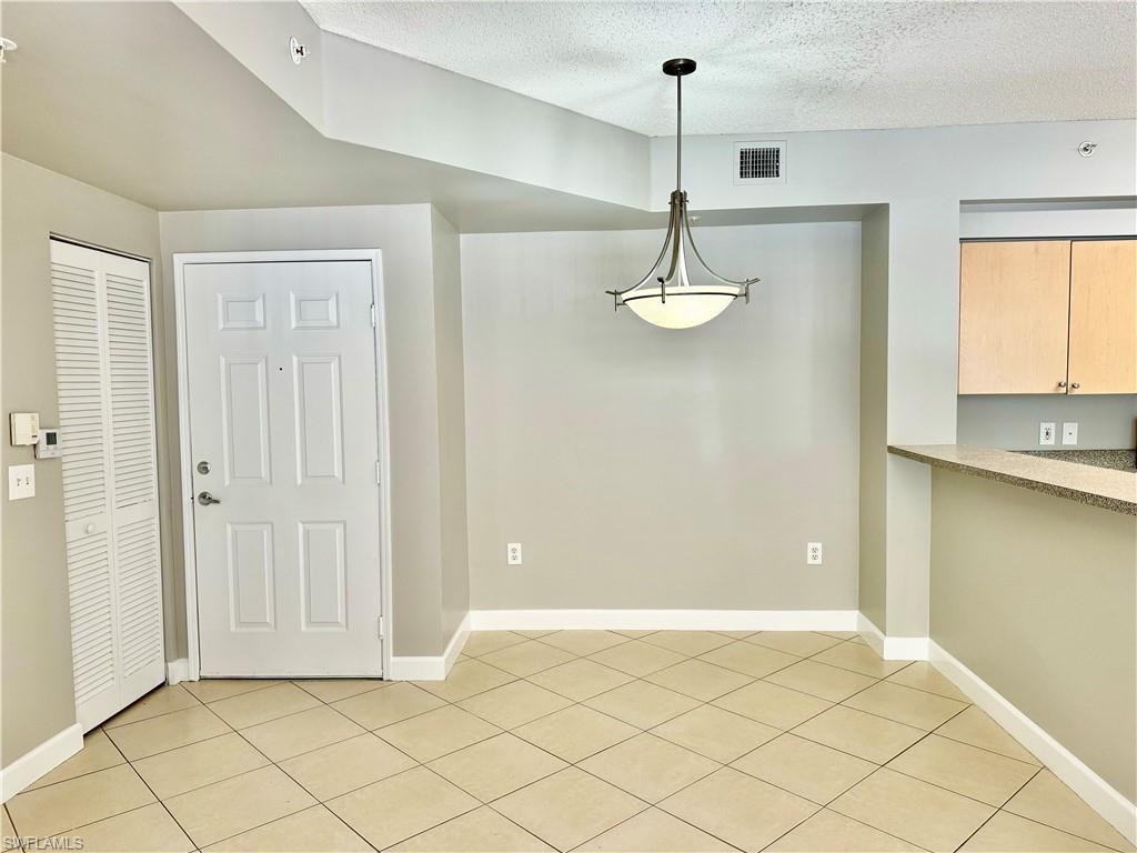 1200 Reserve Way, Unit 103 Naples, FL 34105 - Photo 10 of 26 a view of livingroom with kitchen view and window