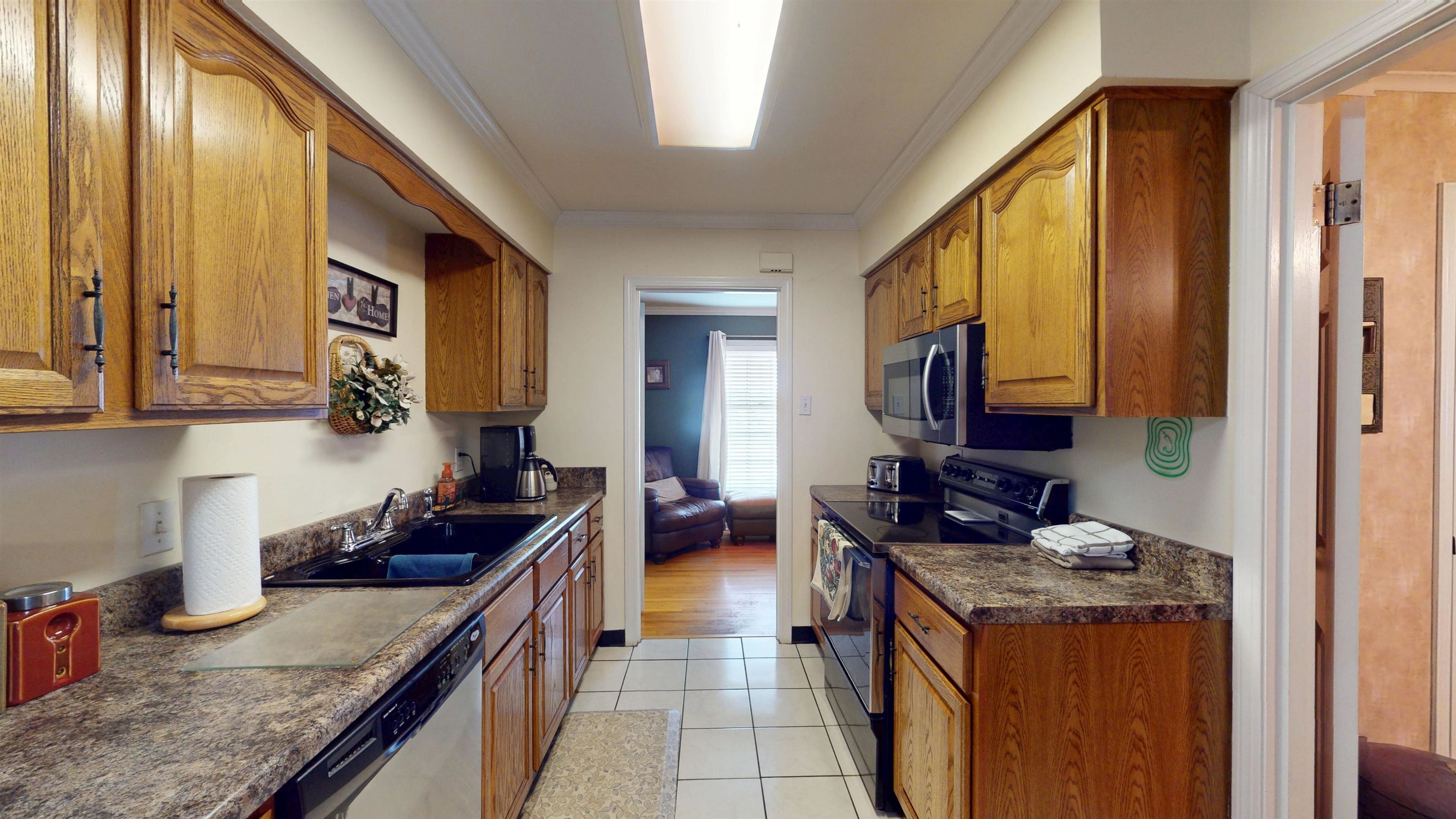 897 Bartlett Road Memphis, TN 38122 - Photo 9 of 33 a kitchen with stainless steel appliances granite countertop a stove a sink and a microwave