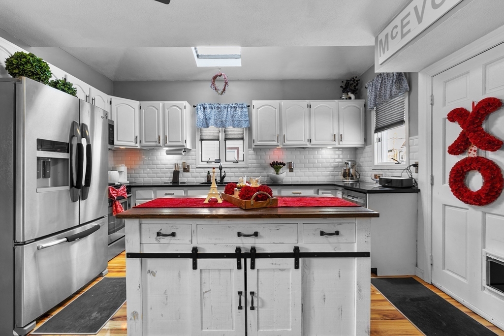 7 Adams Avenue Saugus, MA 01906 - Photo 5 of 38 a kitchen with stainless steel appliances granite countertop a sink stove and refrigerator