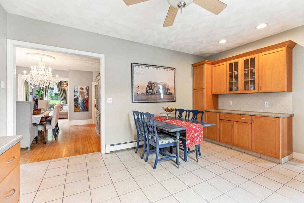 45 Spring Street Stoneham, MA 02180 - Photo 12 of 30 a dining room with furniture and a chandelier