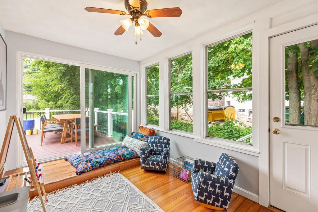 45 Spring Street Stoneham, MA 02180 - Photo 16 of 30 a living room with patio furniture and a floor to ceiling window