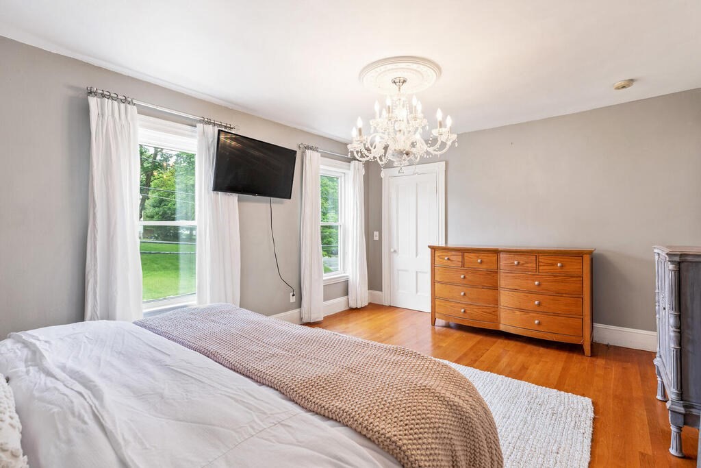 45 Spring Street Stoneham, MA 02180 - Photo 20 of 30 a bedroom with a bed and a flat screen tv