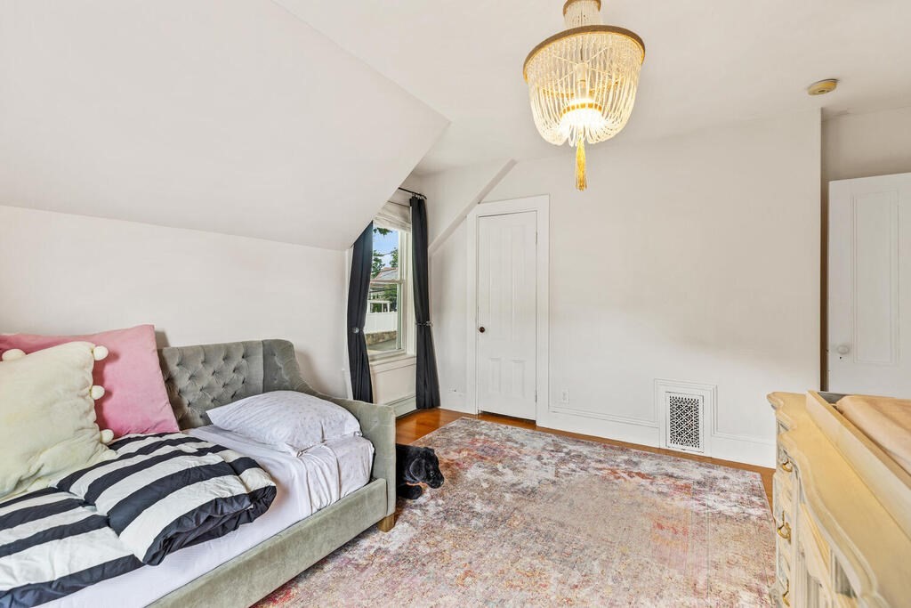 45 Spring Street Stoneham, MA 02180 - Photo 23 of 30 a bedroom with a bed and wooden floor
