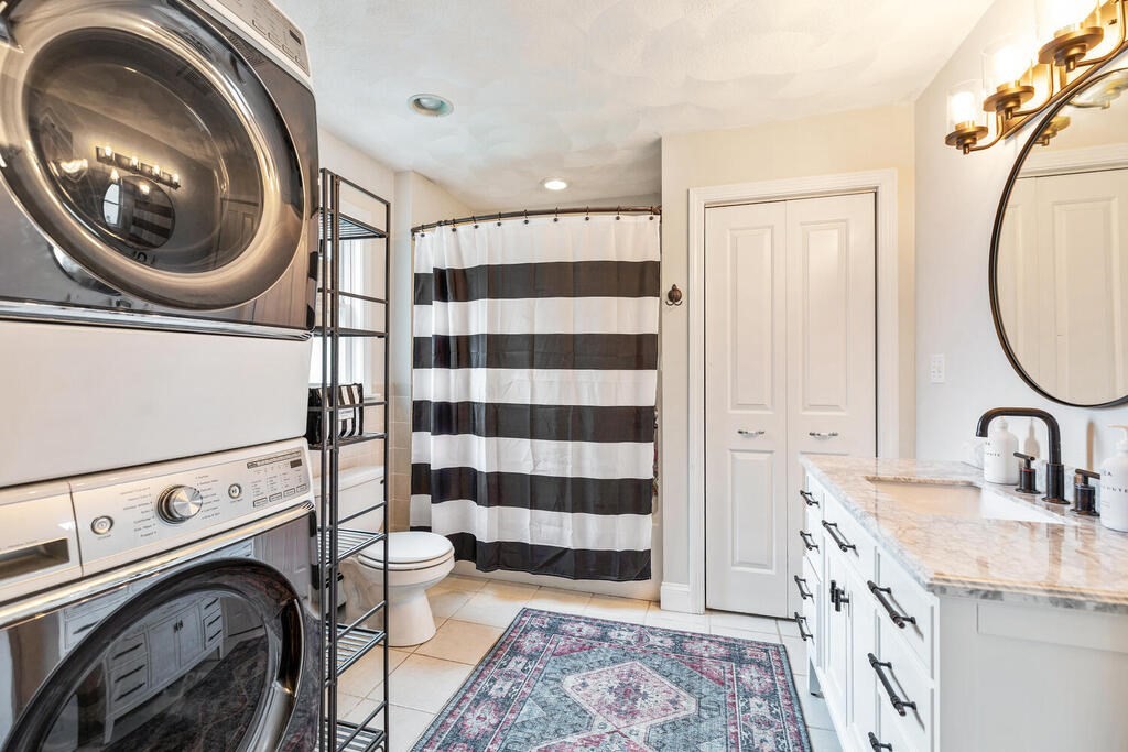 45 Spring Street Stoneham, MA 02180 - Photo 25 of 30 a bathroom with a sink a toilet and a mirror