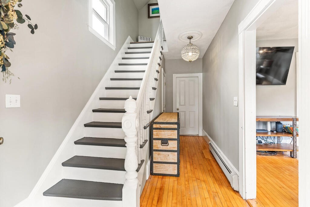 45 Spring Street Stoneham, MA 02180 - Photo 3 of 30 a view of a hallway with wooden floor and entryway