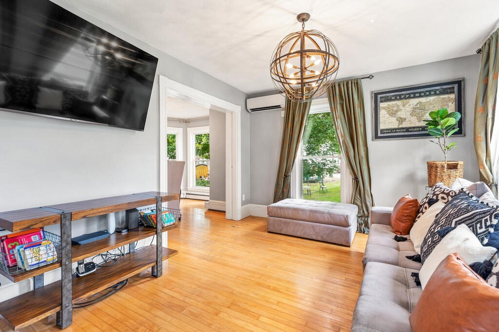 45 Spring Street Stoneham, MA 02180 - Photo 4 of 30 a living room with furniture and a flat screen tv