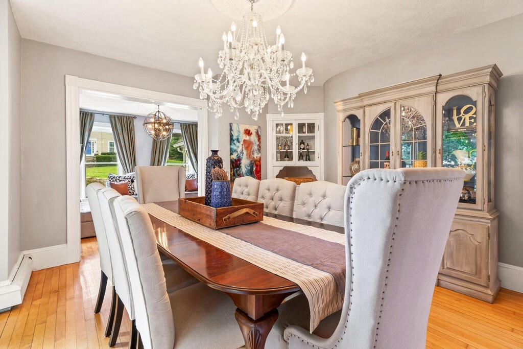 45 Spring Street Stoneham, MA 02180 - Photo 7 of 30 a view of a dining room with furniture a chandelier and wooden floor