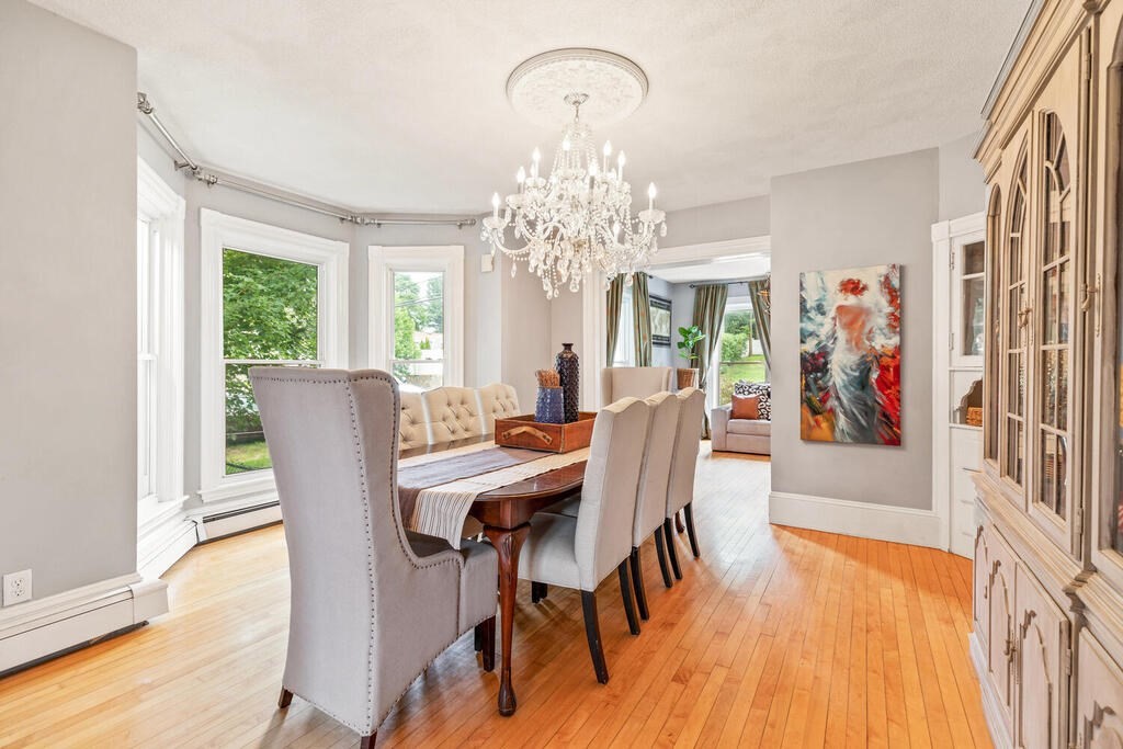 45 Spring Street Stoneham, MA 02180 - Photo 8 of 30 a view of a dining room with furniture a chandelier and wooden floor