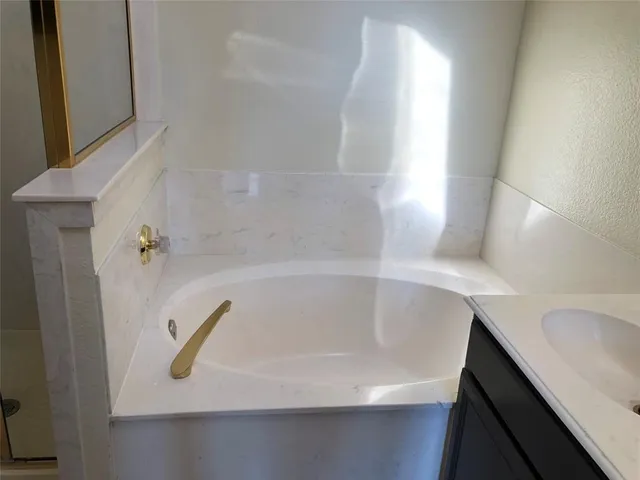 a bathroom with a shower and a sink