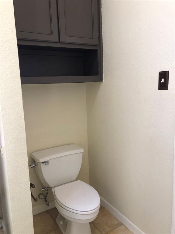 10350 Hampton Court Frisco, TX 75035 - Photo 17 of 27 a white toilet sitting next to a utility room