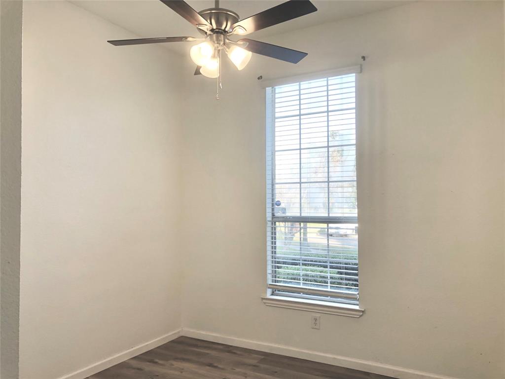10350 Hampton Court Frisco, TX 75035 - Photo 20 of 27 an empty room with windows and fan