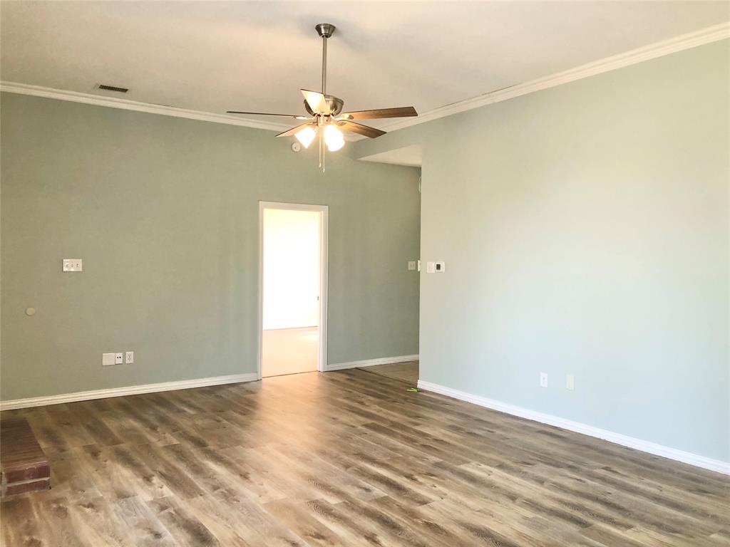 10350 Hampton Court Frisco, TX 75035 - Photo 4 of 27 an empty room with a empty space and a ceiling fan