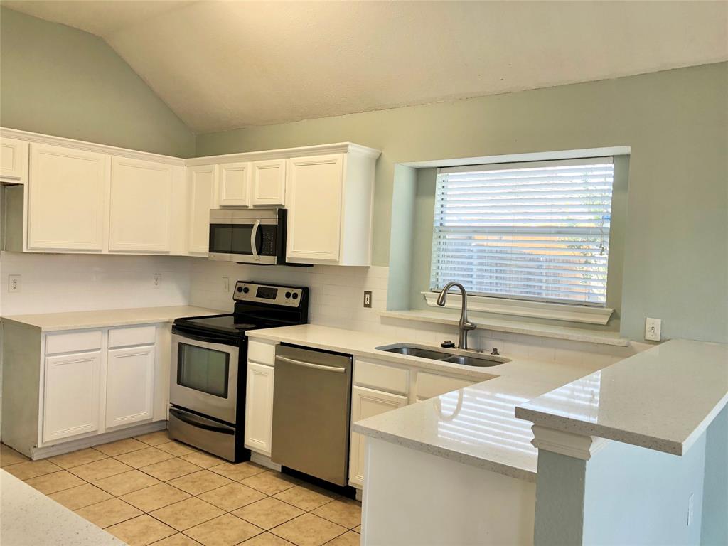 10350 Hampton Court Frisco, TX 75035 - Photo 6 of 27 a kitchen with a sink cabinets and appliances