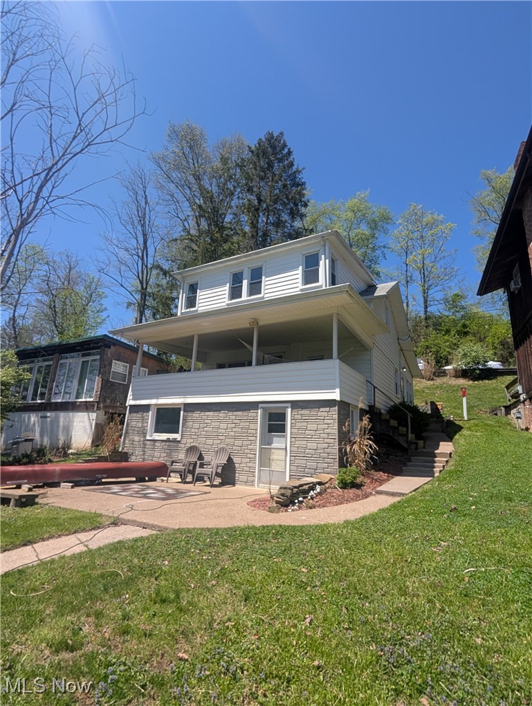 544 Maple Lake Road Bridgeport, WV 26330 - Photo 2 of 20 Rear view of house with stone siding, a yard, and a patio area