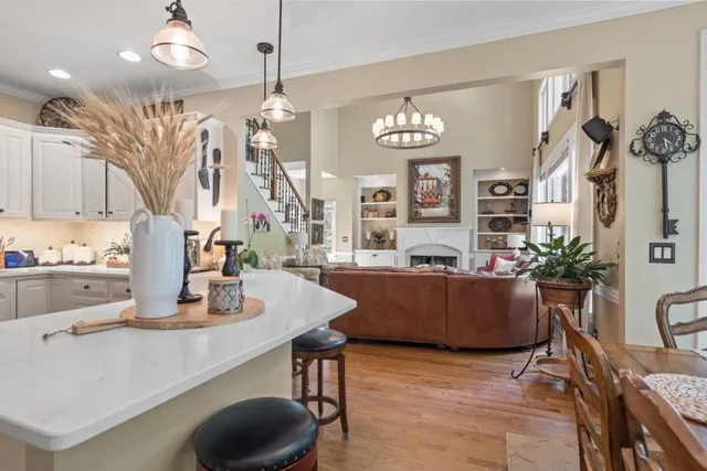 a living room with furniture a fireplace and a large window