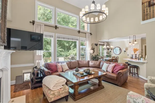 a living room with furniture fireplace and a large window