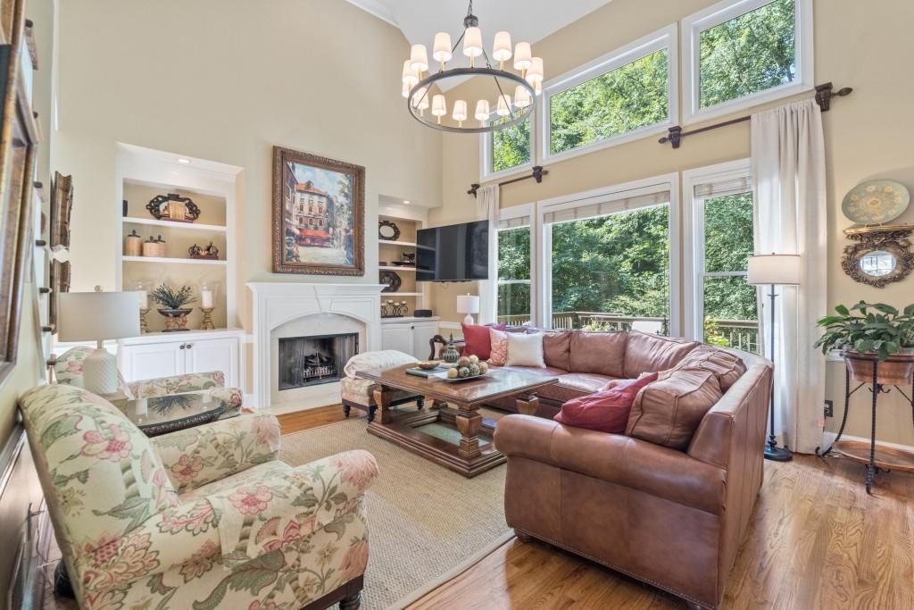 4140 River Bluff Run Way Suwanee, GA 30024 - Photo 13 of 83 a living room with furniture a fireplace and a large window