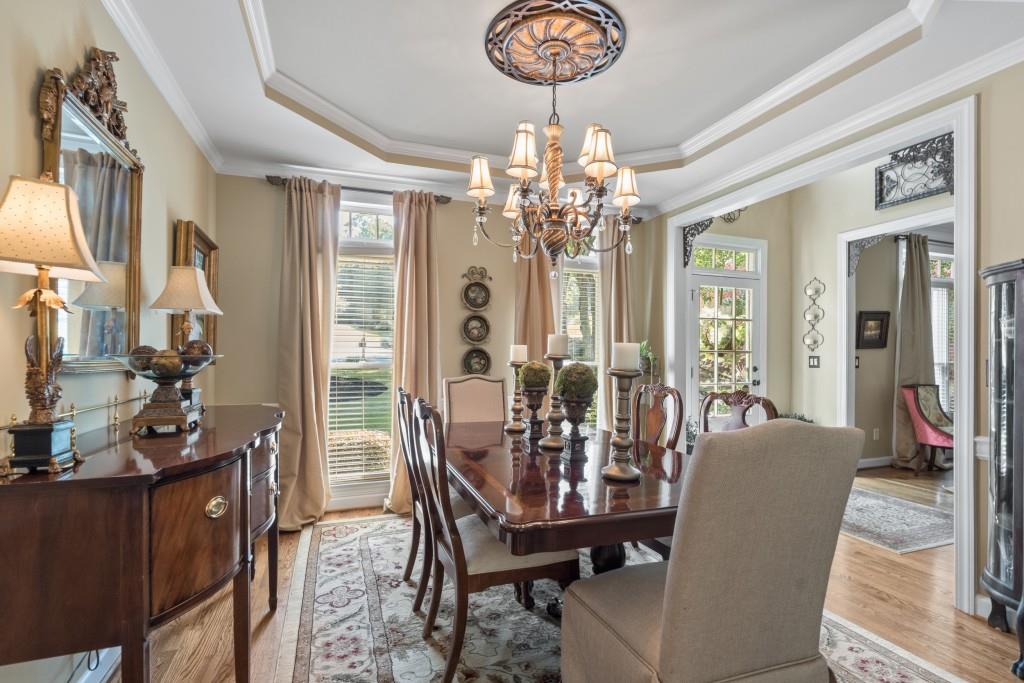 4140 River Bluff Run Way Suwanee, GA 30024 - Photo 18 of 83 a view of a dining room with furniture a chandelier and wooden floor