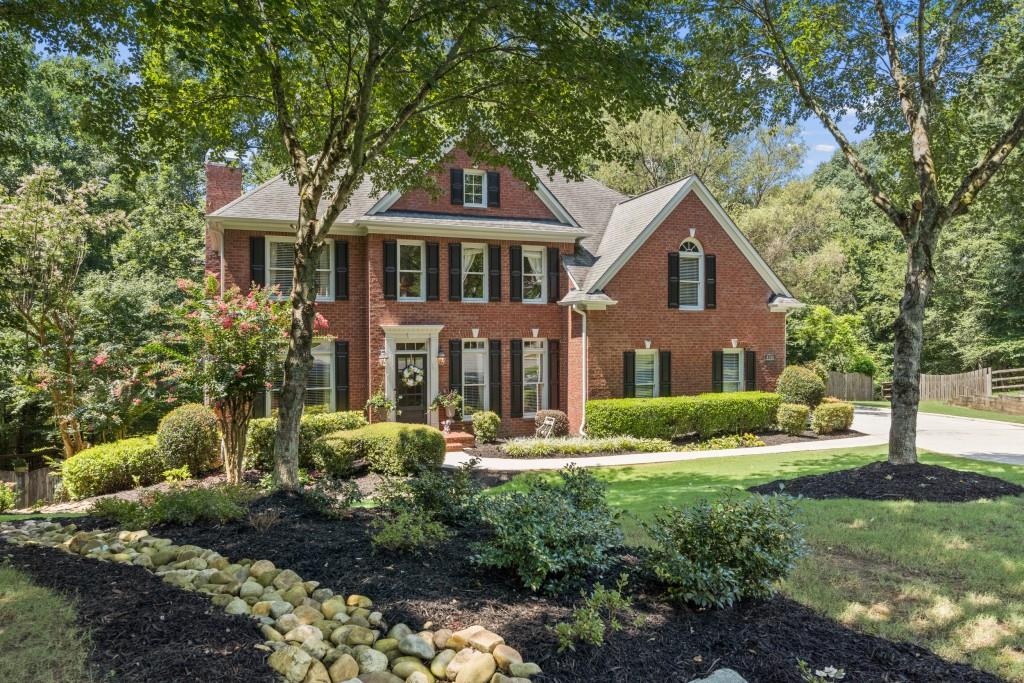 4140 River Bluff Run Way Suwanee, GA 30024 - Photo 2 of 83 a front view of a house with a yard