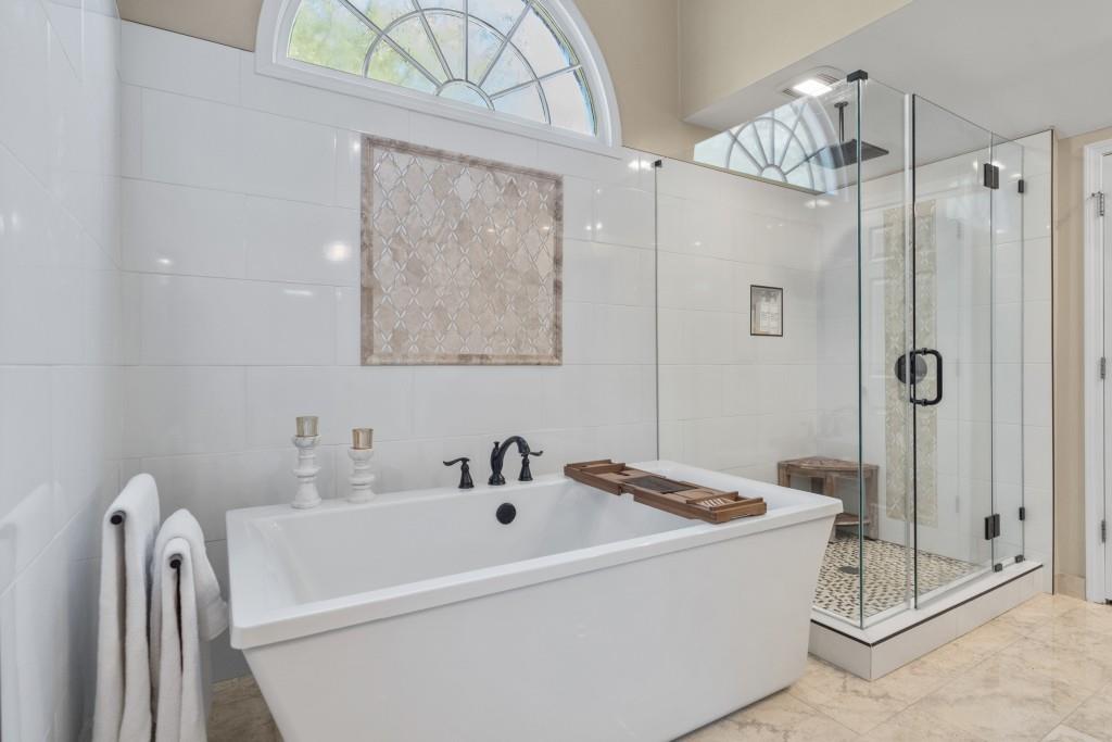 4140 River Bluff Run Way Suwanee, GA 30024 - Photo 25 of 83 a bathroom with a tub a sink and mirror