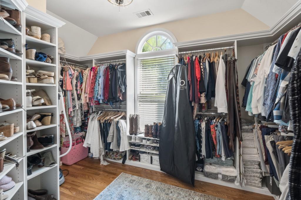 4140 River Bluff Run Way Suwanee, GA 30024 - Photo 31 of 83 a view of walk in closet with clothes and shoes
