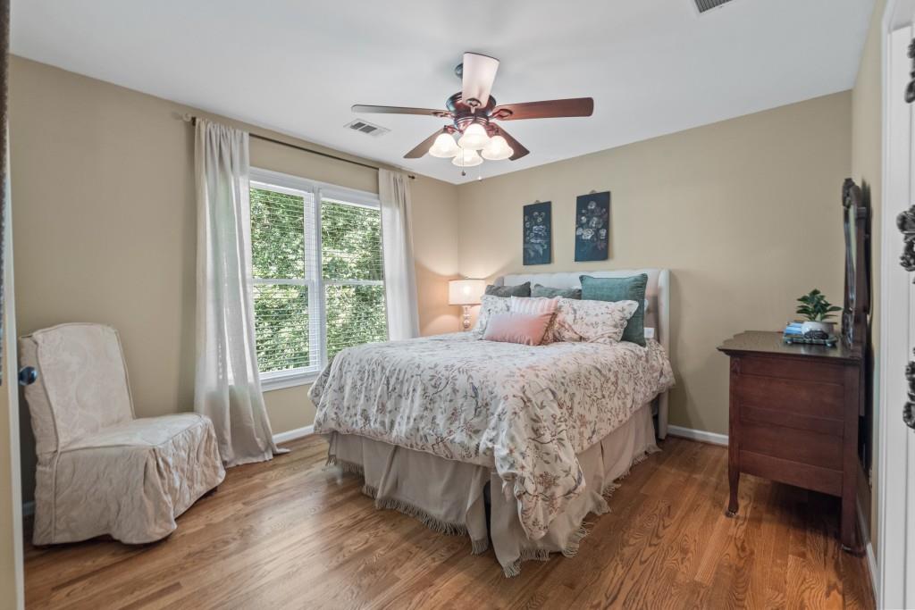 4140 River Bluff Run Way Suwanee, GA 30024 - Photo 32 of 83 a bedroom with a bed and wooden floor