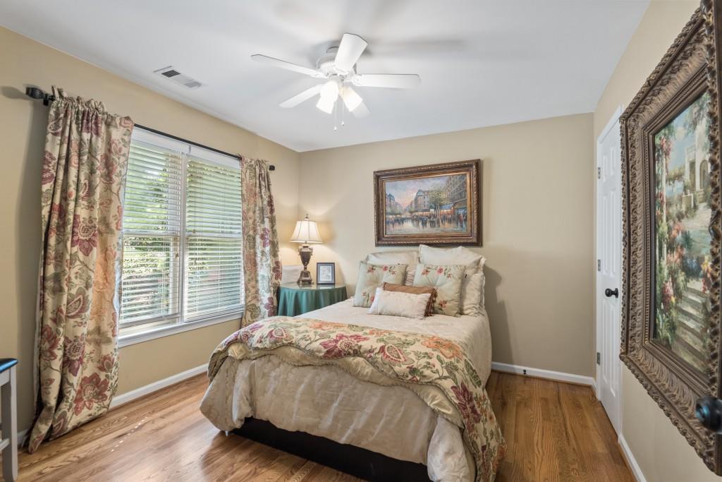 4140 River Bluff Run Way Suwanee, GA 30024 - Photo 33 of 83 a bedroom with a large bed and a chandelier