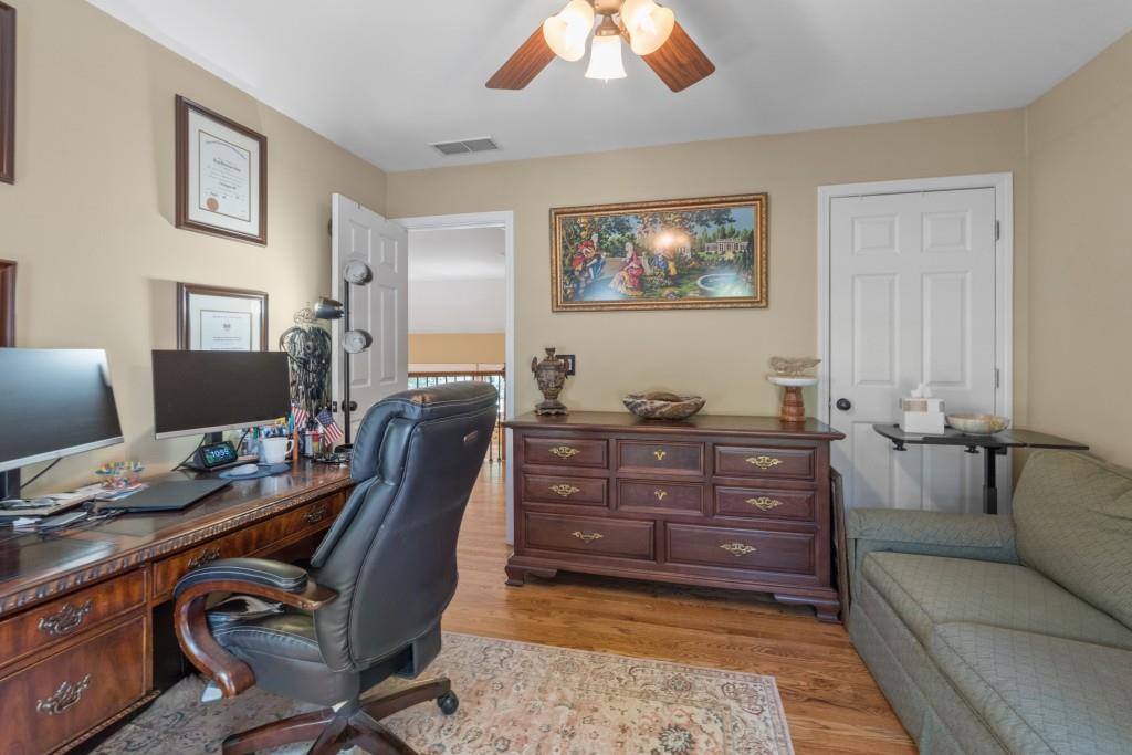 4140 River Bluff Run Way Suwanee, GA 30024 - Photo 38 of 83 a room with a couch and a workspace