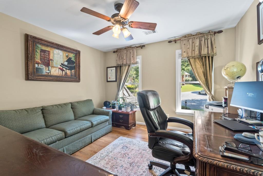 4140 River Bluff Run Way Suwanee, GA 30024 - Photo 39 of 83 a living room with furniture a bed and a window