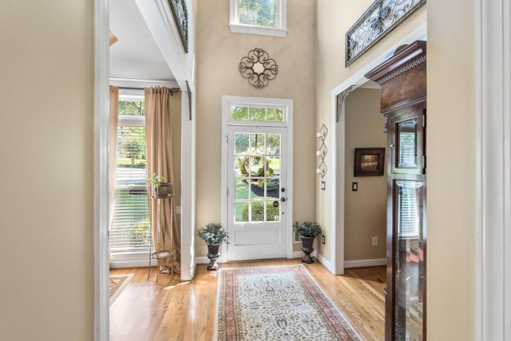 4140 River Bluff Run Way Suwanee, GA 30024 - Photo 4 of 83 a view of an entryway with wooden floor and front door