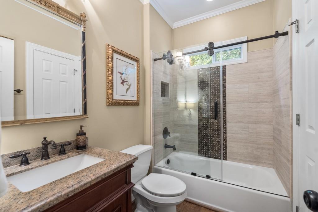 4140 River Bluff Run Way Suwanee, GA 30024 - Photo 41 of 83 a bathroom with a granite countertop sink toilet and shower