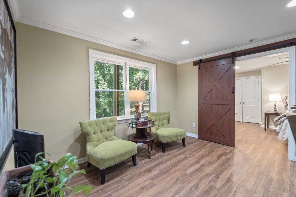4140 River Bluff Run Way Suwanee, GA 30024 - Photo 42 of 83 a living room with furniture and a wooden floor