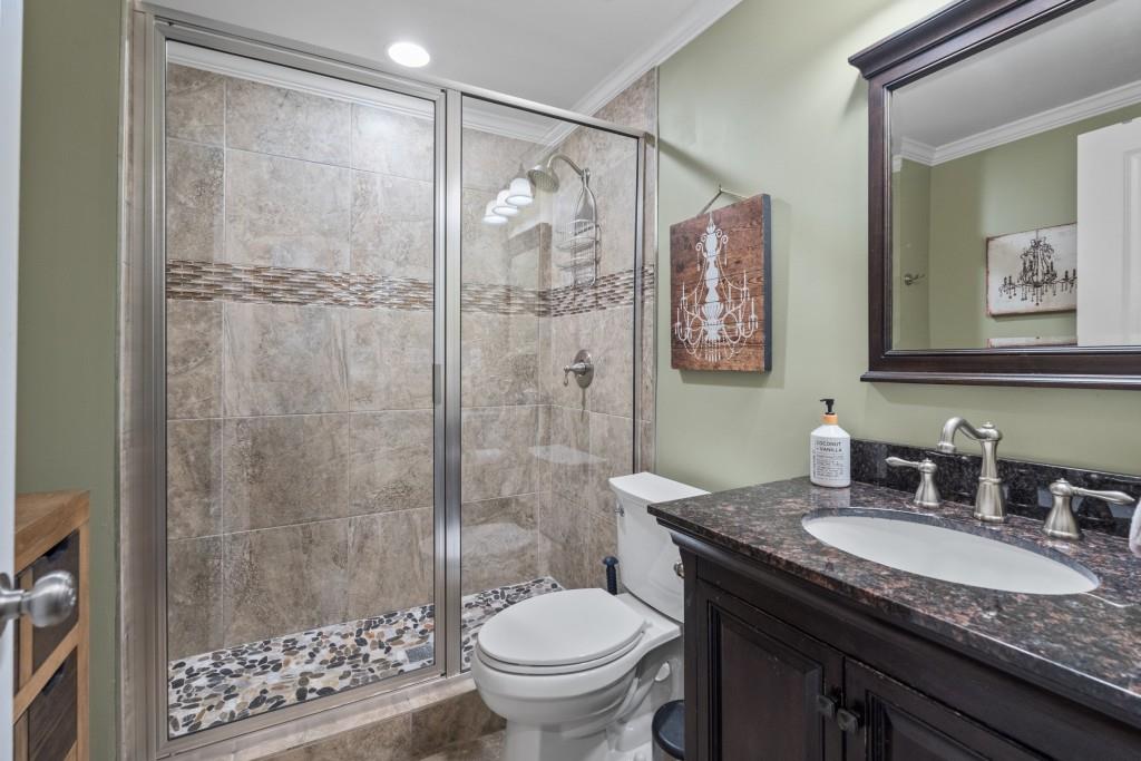 4140 River Bluff Run Way Suwanee, GA 30024 - Photo 45 of 83 a bathroom with a granite countertop sink toilet and shower