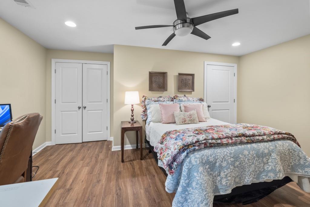 4140 River Bluff Run Way Suwanee, GA 30024 - Photo 46 of 83 a bedroom with a bed a chair and potted plant on the dresser