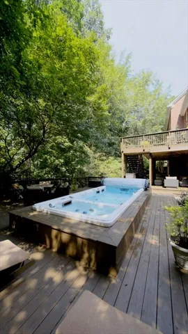 an aerial view of a house with swimming pool and a yard