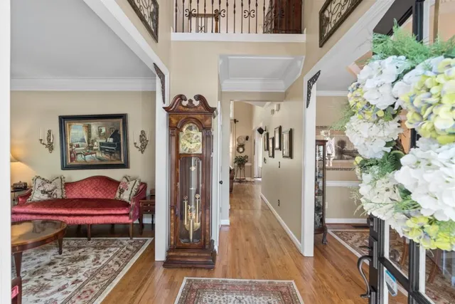 a kitchen with stainless steel appliances granite countertop a refrigerator oven a sink dishwasher and white cabinets with wooden floor