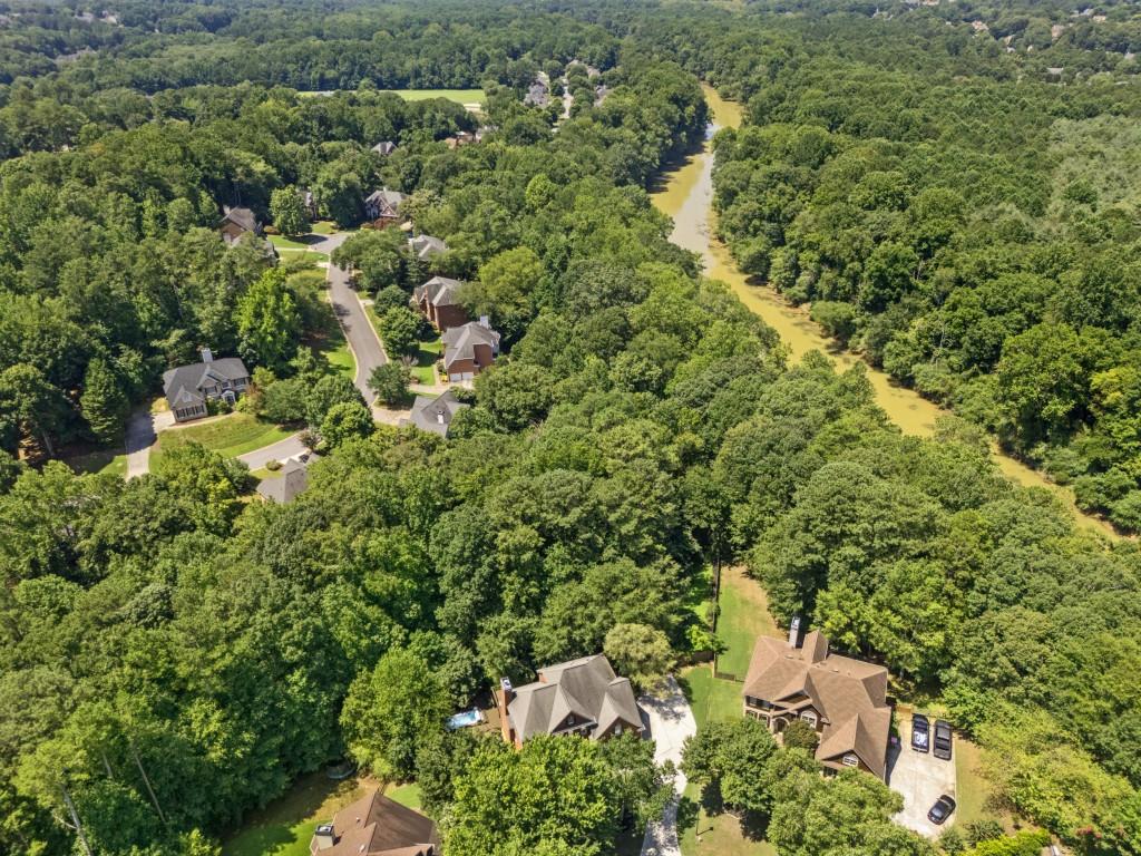 4140 River Bluff Run Way Suwanee, GA 30024 - Photo 67 of 83 a view of a house with a small yard and covered with trees